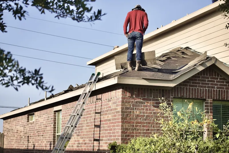 Professional roofer working on a residential roof in Side Creek